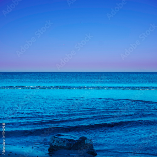 Tranquil Beach Seascape at Twilight with Curving Waves
