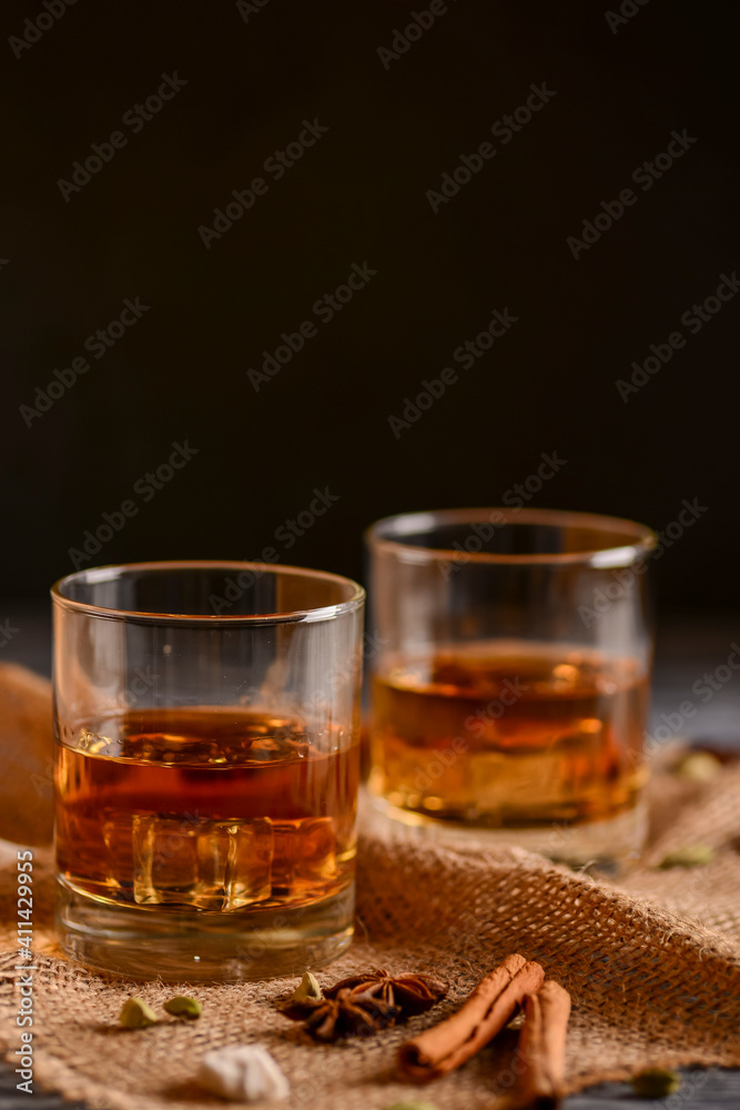 Scotch on wooden background with copyspace. Whiskey in shot glasses. Black background. Scotch on wooden background with copyspace. Whiskey in shot glasses. Black background.