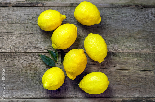 Fresh lemons on a gray wooden background. Copy space for text. High Vitamin C.Top view.