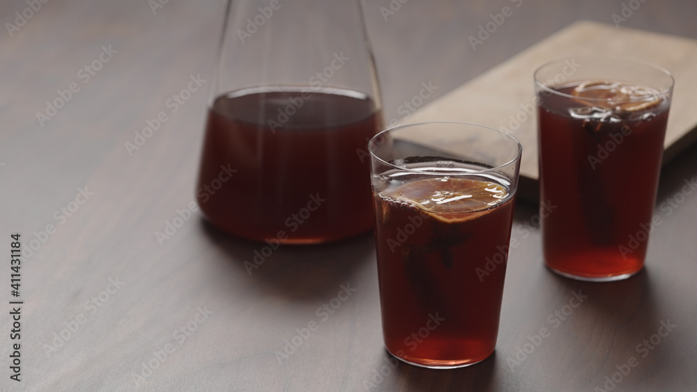 mulled wine in thin tumbler glasses on walnut table mulled wine in thin tumbler glasses on walnut table