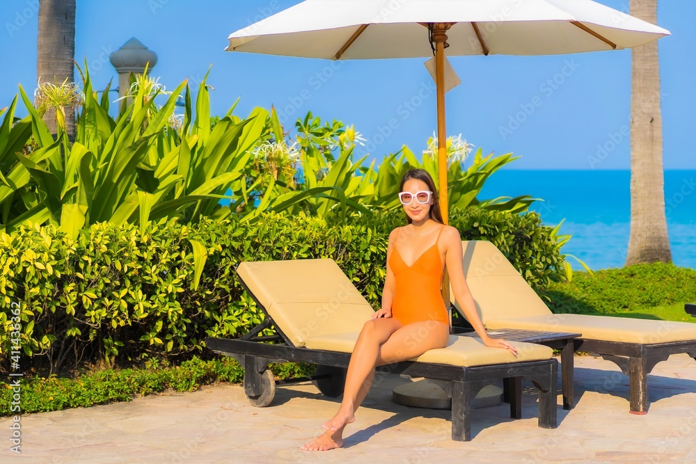 Portrait beautiful young asian woman relax smile leisure around outdoor swimming pool