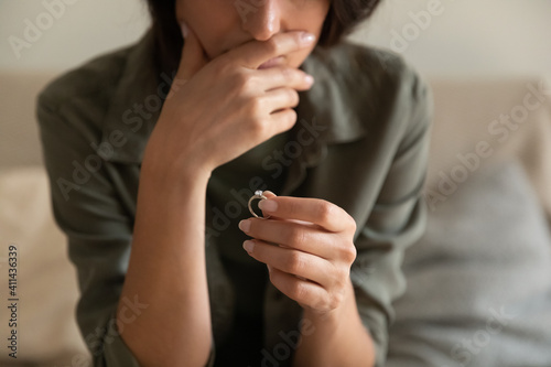 Tablou pe pânză Crop close up of upset woman hold wedding ring think of marriage dissolution or divorce having family problems