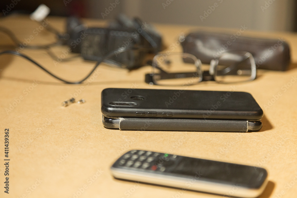 Two smartphones and telephone are on the desktop. Two smartphones and telephone are on the desktop.