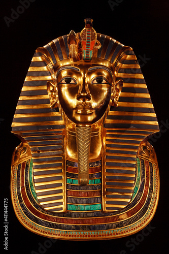Funerary burial mask of egyptian pharaoh Tutankhamun. Isolated on black background. photo