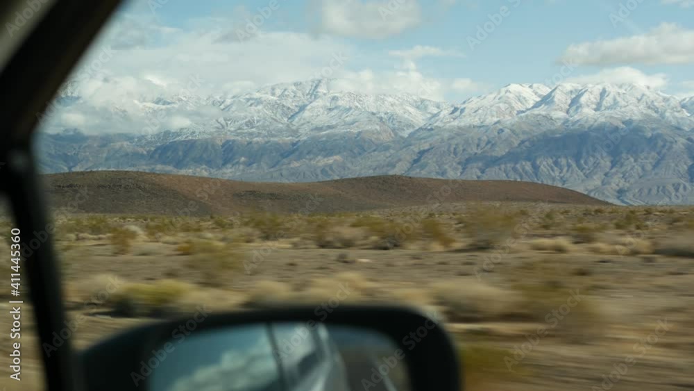 Road trip to Death Valley, driving auto in California, USA. Hitchhiking traveling in America. Highway, mountains and dry desert, arid climate wilderness. Passenger POV from car. Journey to Nevada. Road trip to Death Valley, driving auto in California, USA. Hitchhiking traveling in America. Highway, mountains and dry desert, arid climate wilderness. Passenger POV from car. Journey to Nevada.