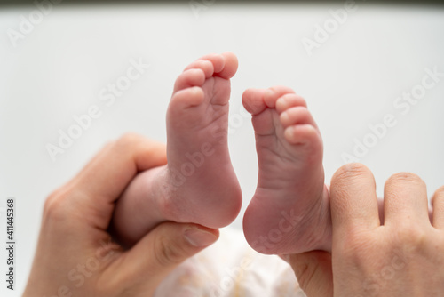 A baby's foot being held in a mother's hand_12