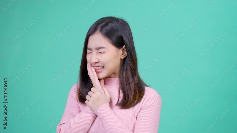 Beautiful smiling of young asian woman with retainer braces with white teeth hurt teeth emotion Beautiful smiling of young asian woman with retainer braces with white teeth hurt teeth emotion