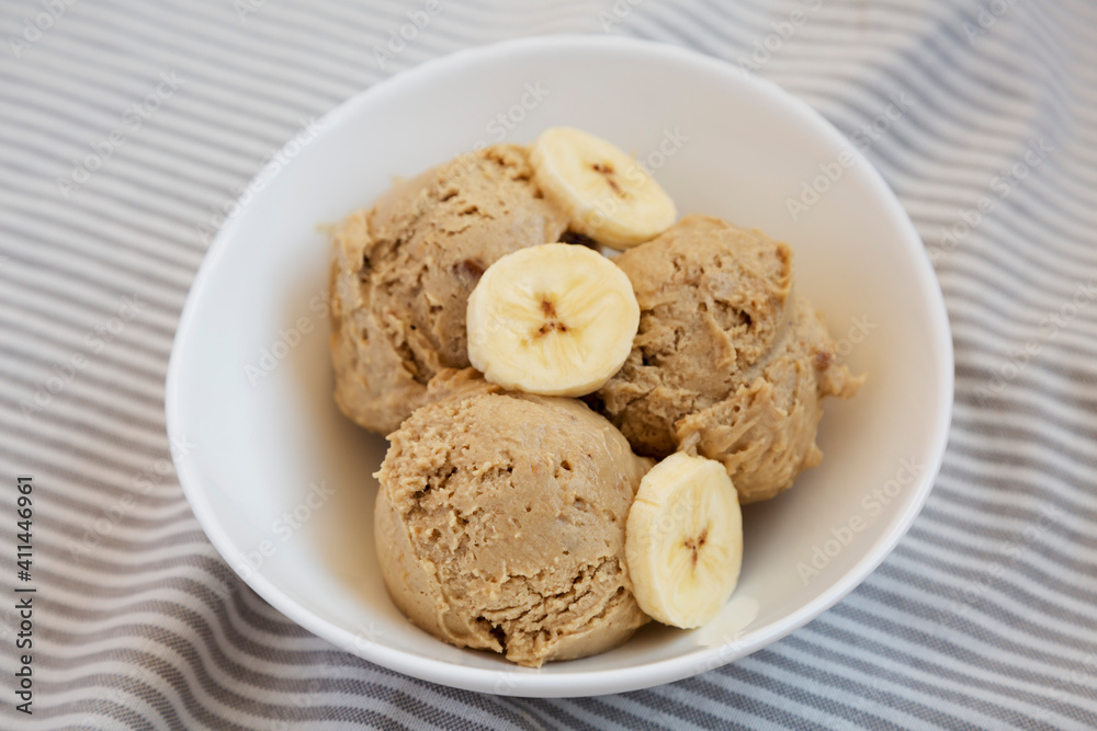 Homemade Peanut Butter Banana Ice Cream in a Bowl, side view. Close-up. Homemade Peanut Butter Banana Ice Cream in a Bowl, side view. Close-up.