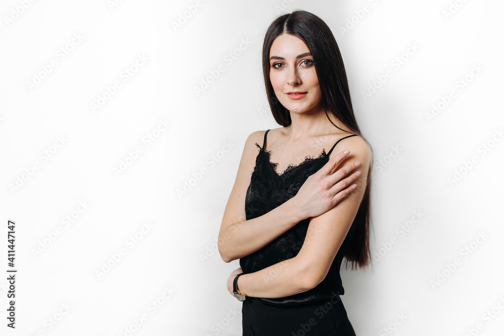 A young beautiful girl in black clothes on a white background. A young beautiful girl in black clothes on a white background.