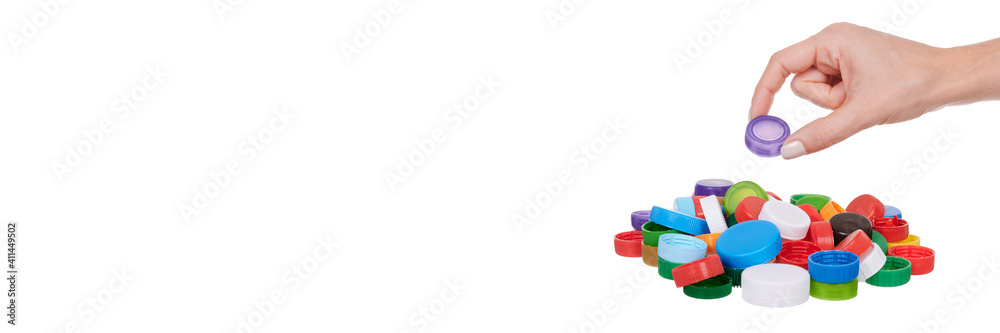Hand with plastic lids, isolated on white background. Hand with plastic lids, isolated on white background.