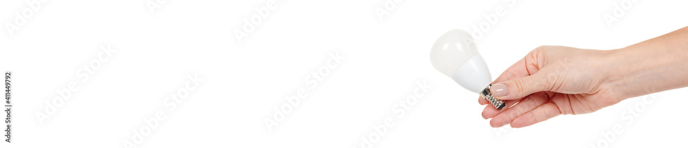 Hand with white LED bulb isolated on white background.