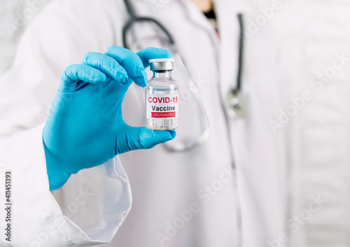 Doctor holding vaccine bottle covid-19 and medical in the hospital