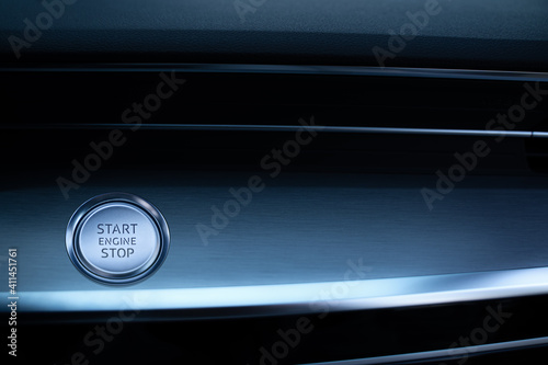 Engine start stop button. Car driver starting the engine.