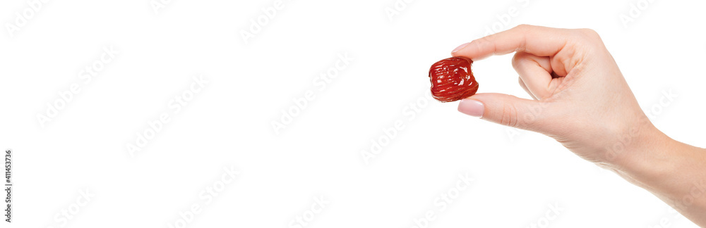Hand with dried date isolated on white background. Hand with dried date isolated on white background.