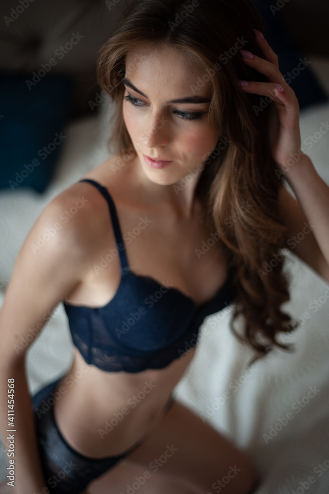 Sensual fashion woman wearing lingerie in the morning on the bed
