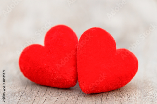 Two red hearts on brown wood table. Valentine day background