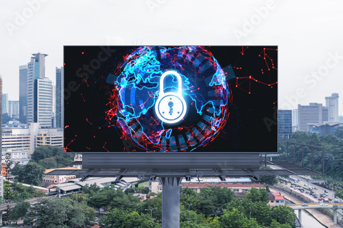 Padlock icon hologram on road billboard over panorama city view of Kuala Lumpur at day time to protect business, Malaysia, Asia. The concept of information security shields.