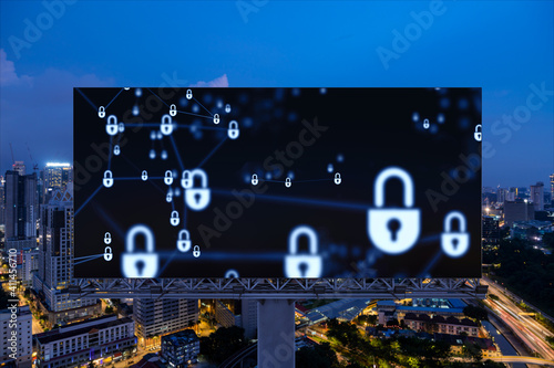 Photography Padlock icon hologram on road billboard over panorama city view of Kuala Lumpur at night to protect business, Malaysia, Asia