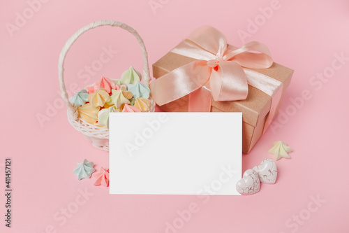 Gifts with note letter on isolated pink background with sweets, love and valentine concept