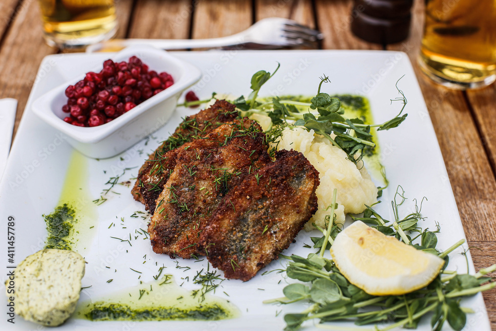 Fried herring, potatoes and lingonberry. Fried herring, potatoes and lingonberry.