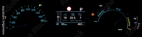 Car dashboard panel in full electric vehicle EV. Illuminated car cluster panel with speedometer, odometer, battery range indicator, power and battery charge gauge. Average battery consumption display.