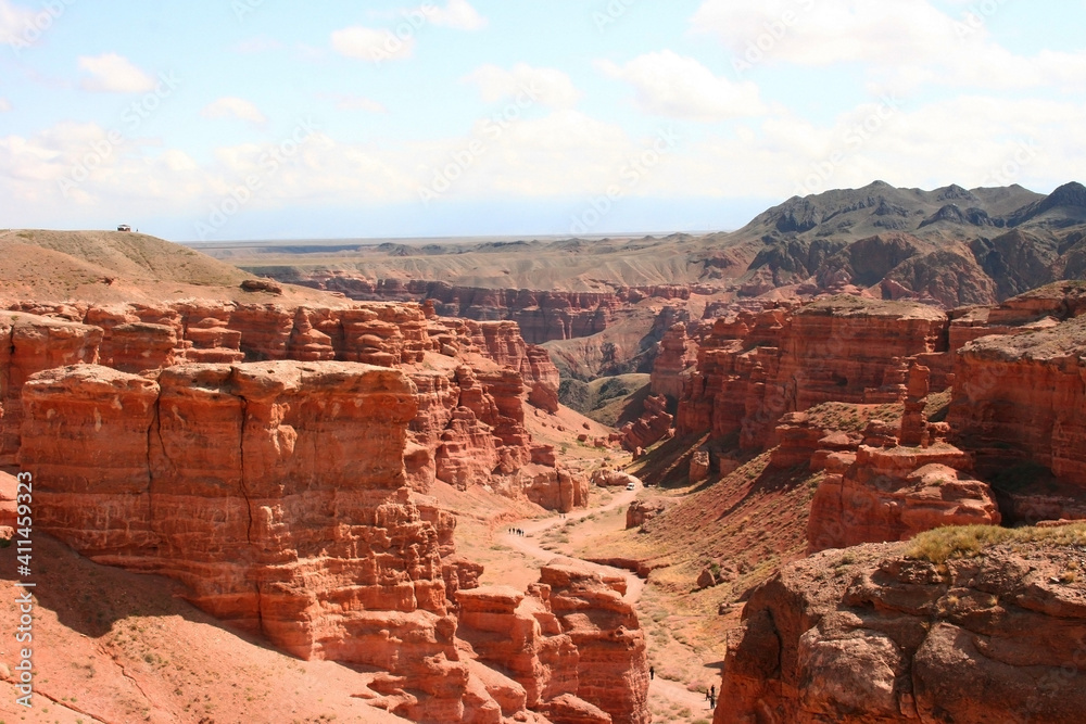 Charyn Canyon in South East Kazakhstan, summer 2019. Red rock canyon trail landscape. Trail in red rock canyon desert. Red rock canyon desert trail landscape. Yellow-red rocks of canyon in Kazakhstan. Charyn Canyon in South East Kazakhstan, summer 2019. Red rock canyon trail landscape. Trail in red rock canyon desert. Red rock canyon desert trail landscape. Yellow-red rocks of canyon in Kazakhstan.