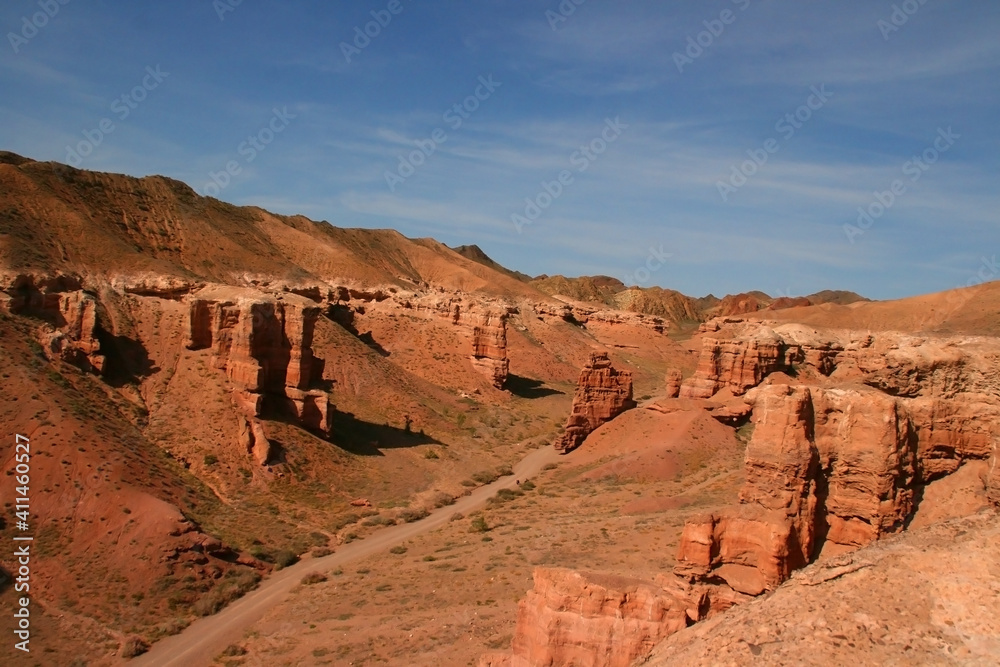 Charyn Canyon in South East Kazakhstan, summer 2019. Red rock canyon trail landscape. Trail in red rock canyon desert. Red rock canyon desert trail landscape. Yellow-red rocks of canyon in Kazakhstan. Charyn Canyon in South East Kazakhstan, summer 2019. Red rock canyon trail landscape. Trail in red rock canyon desert. Red rock canyon desert trail landscape. Yellow-red rocks of canyon in Kazakhstan.