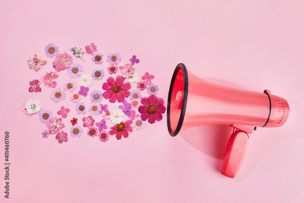 Pink megaphone with colorful flowers on pink background. Minimal nature concept. - obrazy, fototapety, plakaty 
