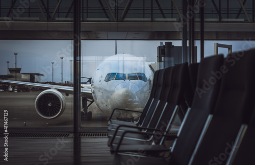 Parked aircraft on an airport through the gate window.