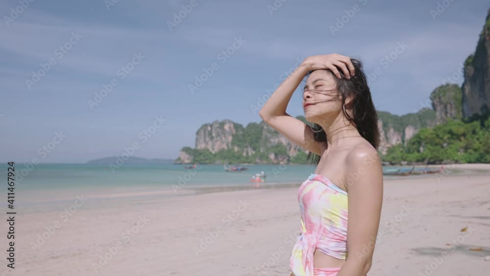 Attractive Young Asian girl enjoying a breeze by a beautiful sea on holiday, Asia natural resources, natural black hair flowing though the wind, beauty shooting, beauty in nature, relaxing activity Attractive Young Asian girl enjoying a breeze by a beautiful sea on holiday, Asia natural resources, natural black hair flowing though the wind, beauty shooting, beauty in nature, relaxing activity