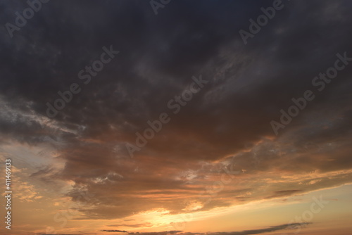 Scenic cloudy sky in the glowing of the sun in the sunset