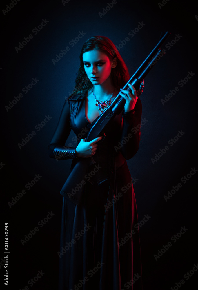 Vampire in black long corset dress in smoke holding a gun Vampire in black long corset dress in smoke holding a gun