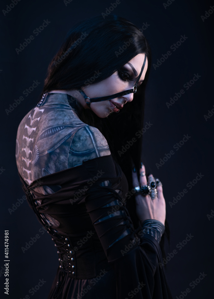 Young woman in black dress in Gothic style