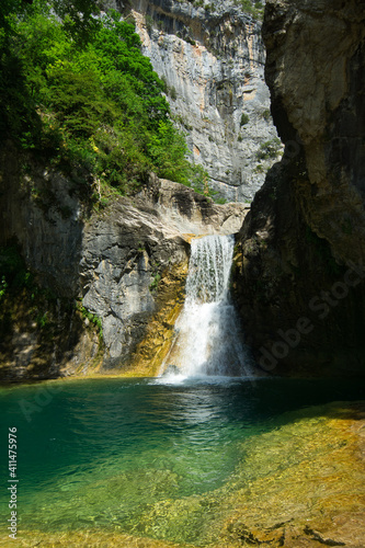 Majestic Hidden Waterfall in Natural Landscape, located in the Aragonese Pyrenees, Huesca, Spain.