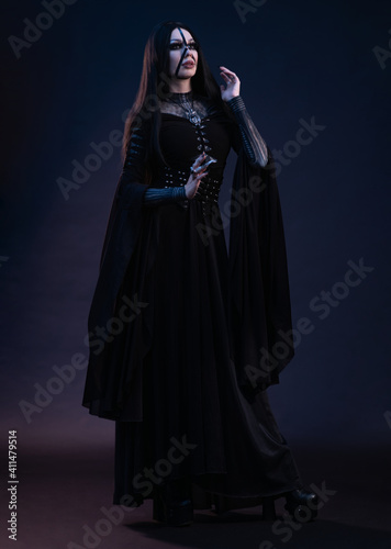 Young woman in black dress in Gothic style