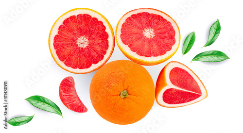 Creative layout made of Grapefruits and green leaves isolated on white background. Pink grapefruit slices Flat lay. Top view. .