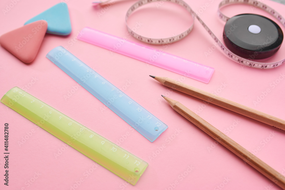 Stationery supplies closeup, pink background
