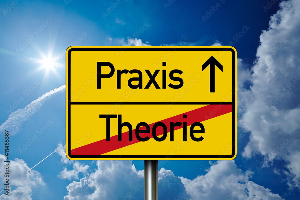 Road sign with the german words for practice and theory - Praxis und Theorie in front of a blue sky Road sign with the german words for practice and theory - Praxis und Theorie in front of a blue sky