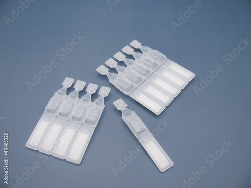 Set Lubricant eye drops in plastic pipettes blue background