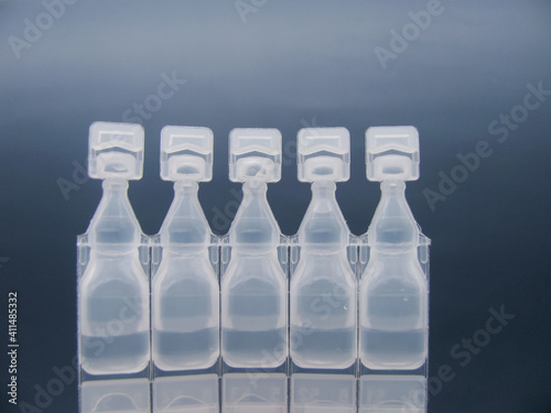 Set Lubricant eye drops in plastic pipettes blue background