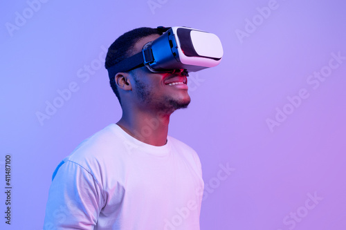 Modern technologies for entertainment. Excited black man wearing vr glasses looking aside © Prostock-studio
