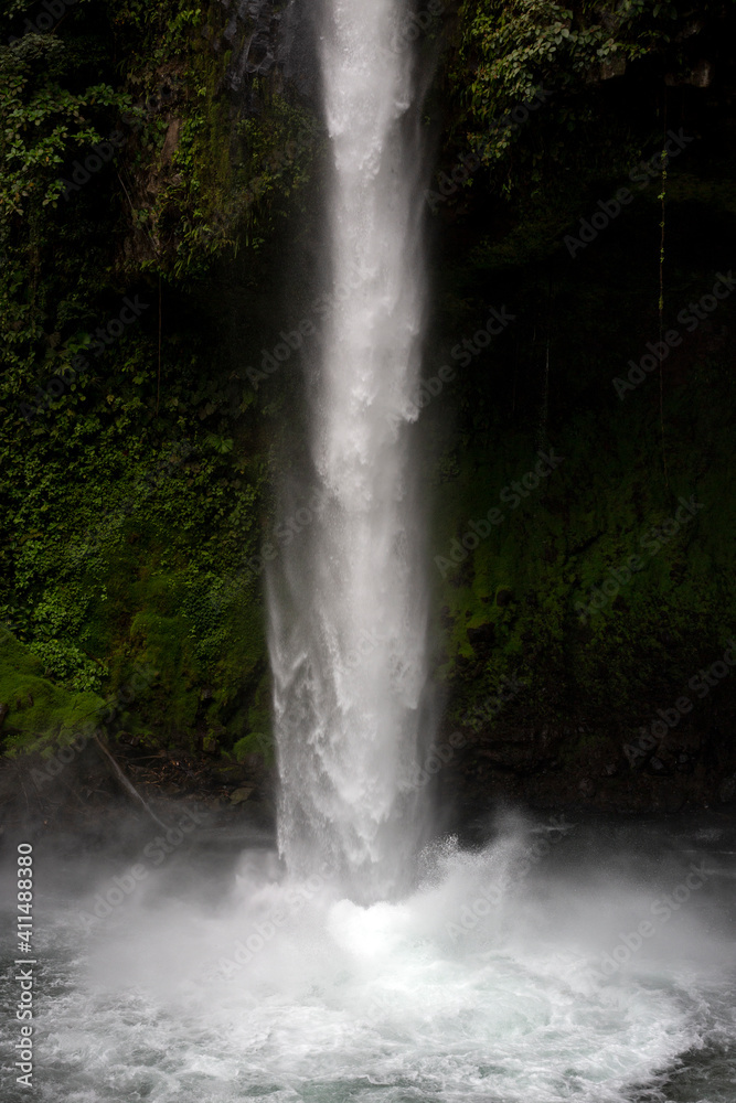 Tropical La Fortuna Waterfall in Costa Rica surrounded by rainforest vegetation Tropical La Fortuna Waterfall in Costa Rica surrounded by rainforest vegetation