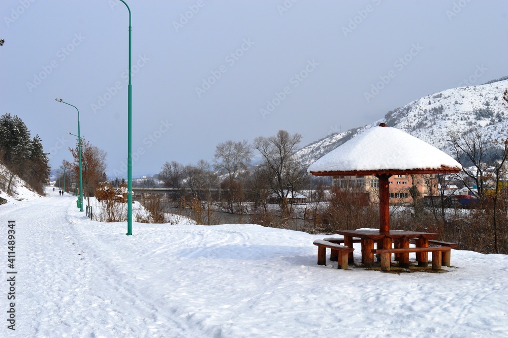wooden summer house under the snow in winter