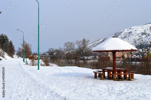 wooden summer house under the snow in winter