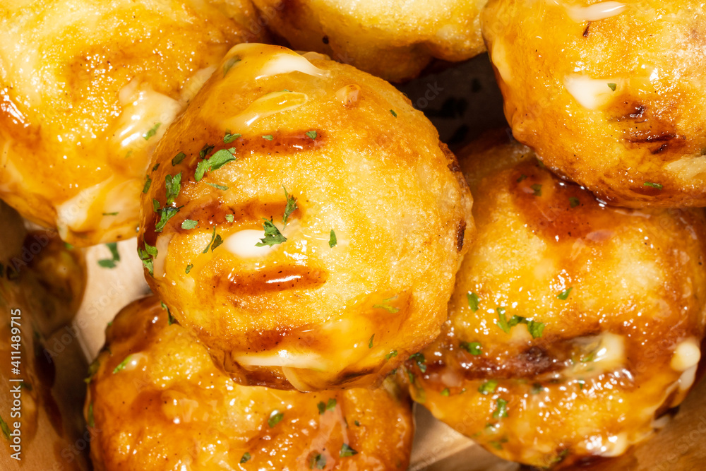 It is a round-roasted takoyaki dish with octopus in flour dough It is a round-roasted takoyaki dish with octopus in flour dough