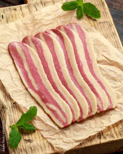 Raw plant based vegan Bacon pieces on crumpled paper photo