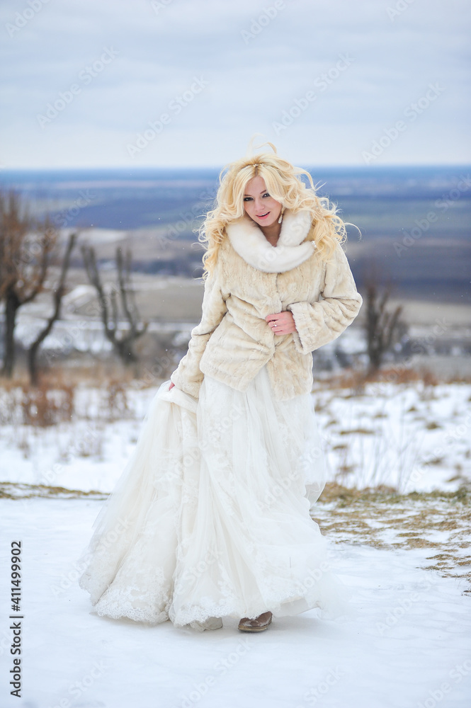 Beautiful bride near old castle on winter wedding day Beautiful bride near old castle on winter wedding day