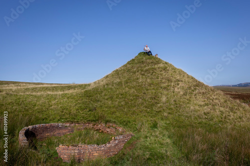 man sitting on hill at ancient mine in scotland