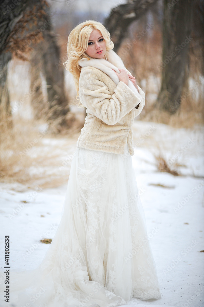 Portrait of a beautiful young woman, bride, in a winter forest Portrait of a beautiful young woman, bride, in a winter forest