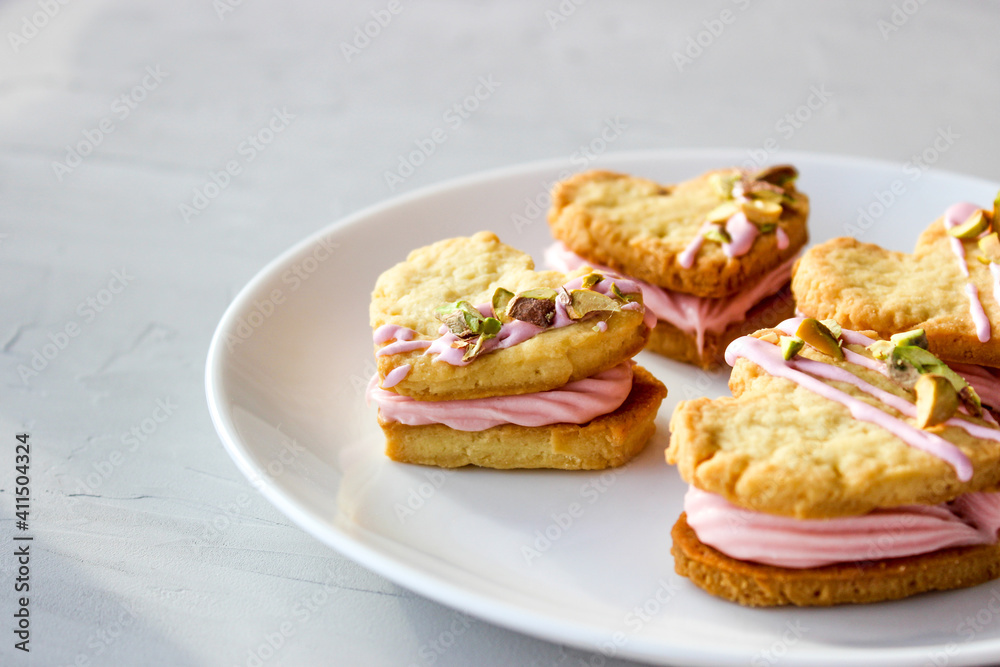 Holiday cookies in the shape of a heart, with cottage cheese cream and pistachios Holiday cookies in the shape of a heart, with cottage cheese cream and pistachios
